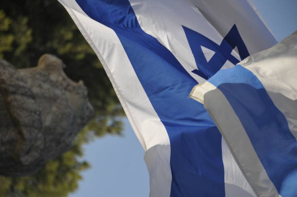 istock Israeli flags in a cemetery 858203348