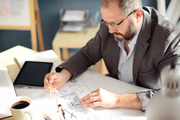 istock Mature Adult man working in the office (engineer) 858204256