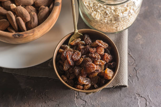 Almond with raisins in a dish of wood stock photo