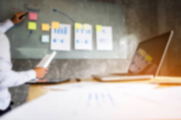 istock Blurred background of Business executive making presentation to colleagues in office, during meeting, explaining, consultation 858205580