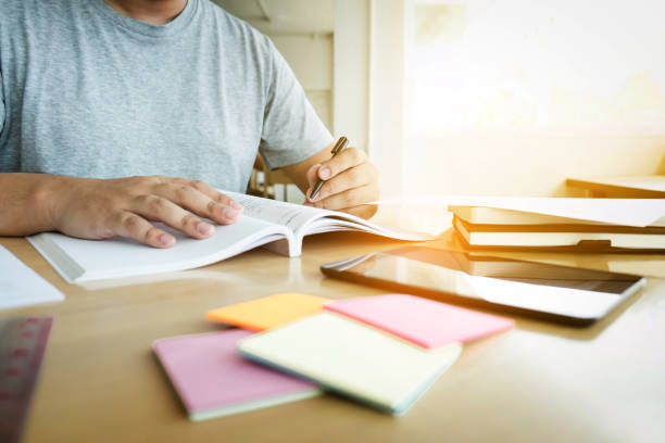 istock Close up of studying student hands writing in book during lecture education students college of university, Reading, Learning and Exam. Education concept 858205586