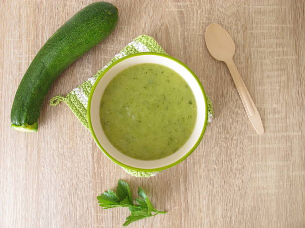 Homemade zucchini soup in soup bowl stock photo
