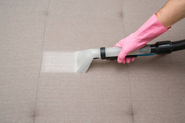 istock Sofa chemical cleaning with professionally extraction method. Hand in rubber protective glove holding nozzle of extractor. Upholstered furniture. Early spring or regular clean up. 858208610