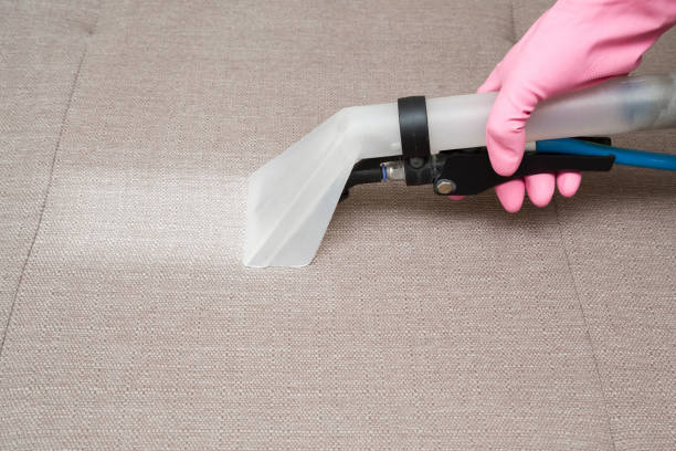 istock Sofa chemical cleaning with professionally extraction method. Hand in rubber protective glove holding nozzle of extractor. Upholstered furniture. Early spring or regular clean up. 858208694