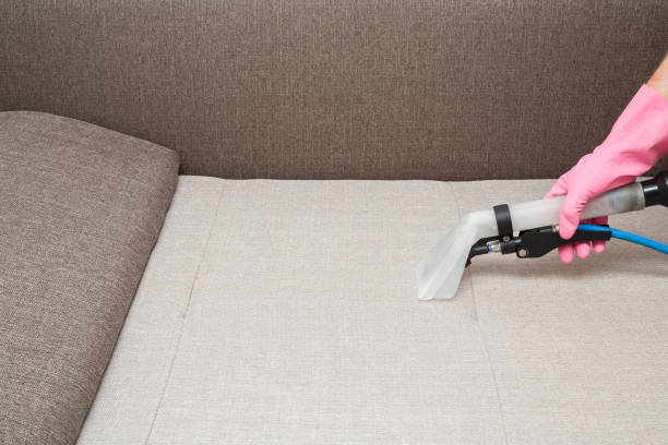 istock Sofa chemical cleaning with professionally extraction method. Hand in rubber protective glove holding nozzle of extractor. Upholstered furniture. Early spring or regular clean up. 858208798