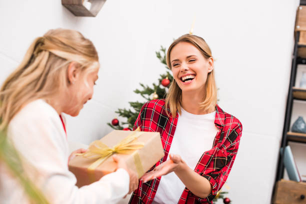 istock mother and daughter with christmas present 858212756