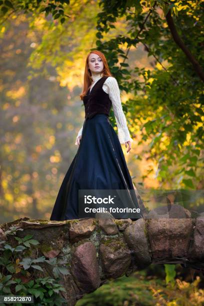 Redhaired Woman In Victorian Outfit With Autumn Park Stock Photo - Download Image Now