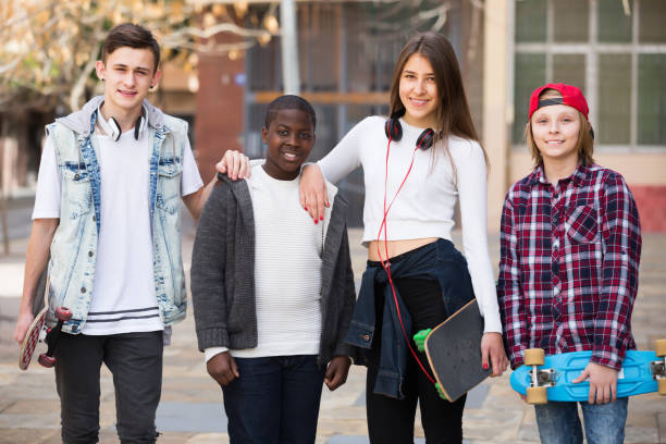 istock Laughing four friends with skateboards 858215748
