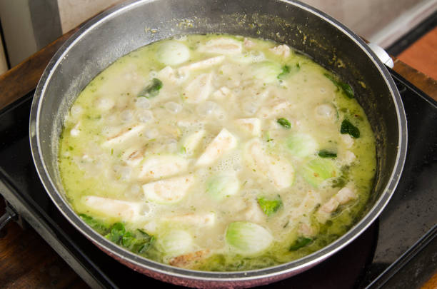 istock Thai food cooking, Green curry cooking in pan 858216566