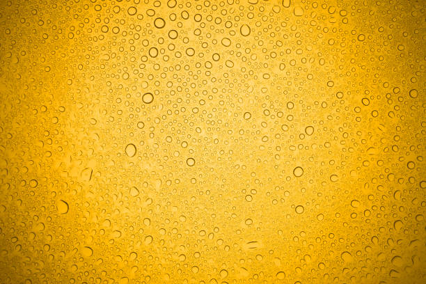 istock Water drops on yellow glass, Rain droplets on glass background. 858218946