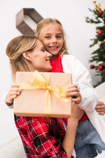 istock mother and daughter with christmas present 858219402