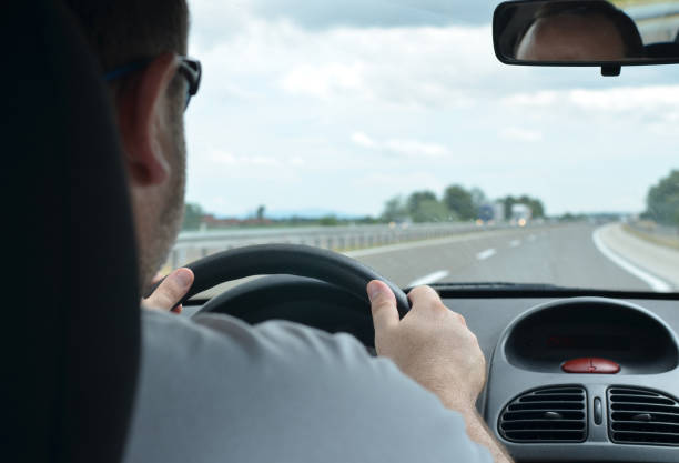istock Man driving a car on a motorway 858223006