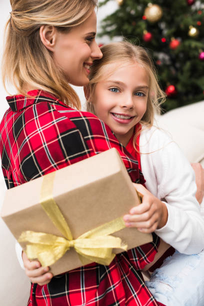 istock mother and daughter with christmas present 858223148