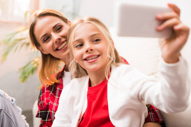 istock mother and daughter taking selfie 858223244