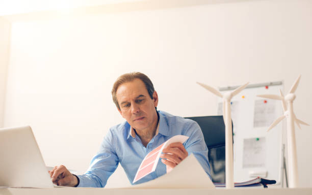 istock Serious smart man looking at the colour palette 858224332