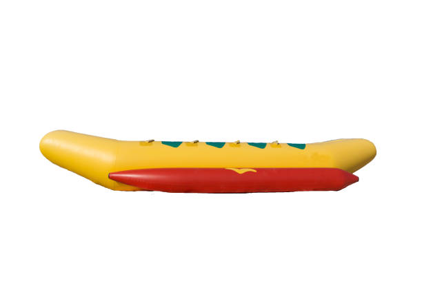 banana gialla e rossa come intrattenimento sulla spiaggia isolato su sfondo bianco - nautical vessel inflatable isolated empty foto e immagini stock