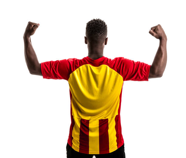 istock Fan / Sport Player on red and yellow uniform celebrating on white background 858226202