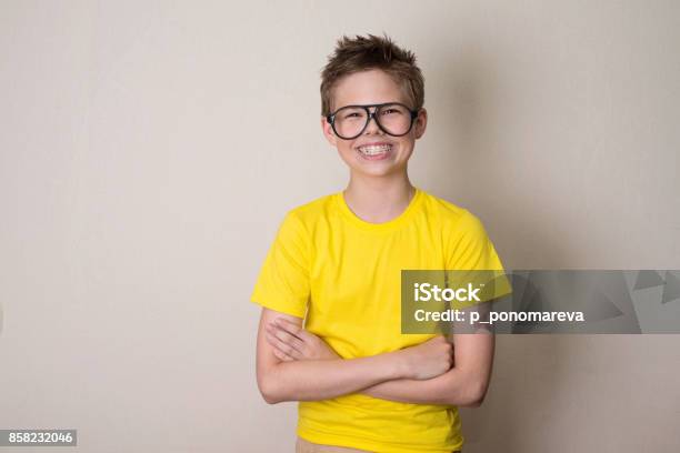 Health Education And People Concept Happy Teen Boy In Braces And Eyeglasses Smiling Stock Photo - Download Image Now