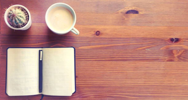 istock Blank notebook with pen, cactus and coffee on wooden table. Copy space. 858233274