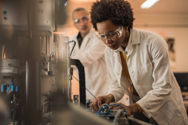 istock African American engineer testing quality of a machine part in a laboratory. 858235476