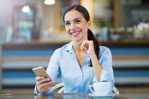 istock Woman with coffee and smart phone 858243384
