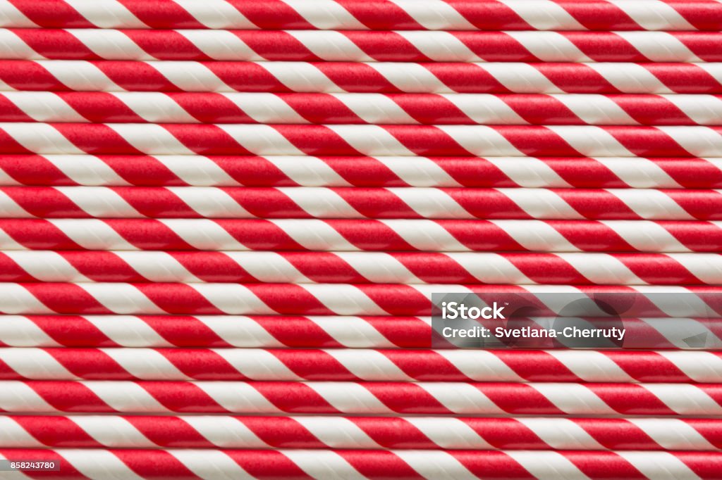 Christmas red straws as background. Top view. Pattern. Christmas red straws as background. Holiday card. Top view. Pattern Drinking Straw Stock Photo