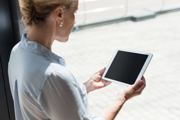 istock mature woman with digital tablet 858244986
