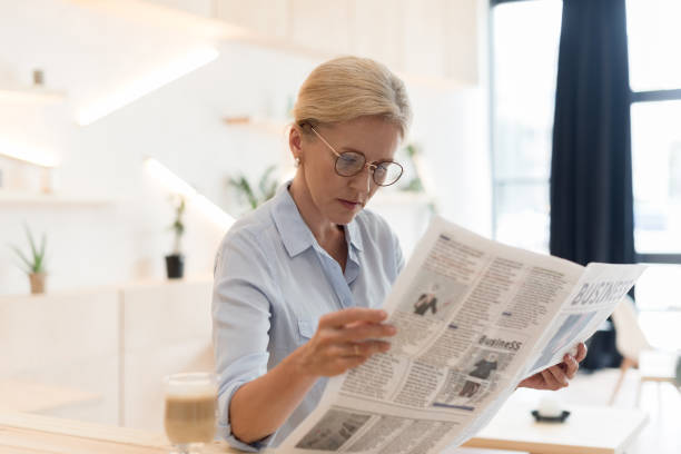 istock businesswoman reading newspaper 858245428