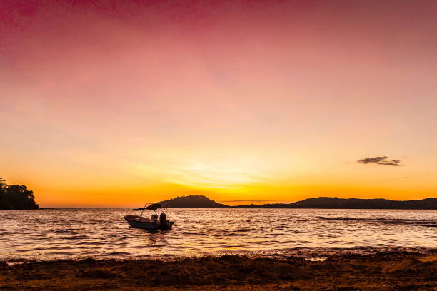 Sunset on the Beach in Nosy Be Island with Ship.