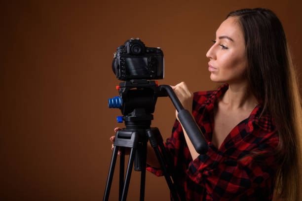istock Studio shot of young beautiful woman getting ready for vlogging against colored background 858247880