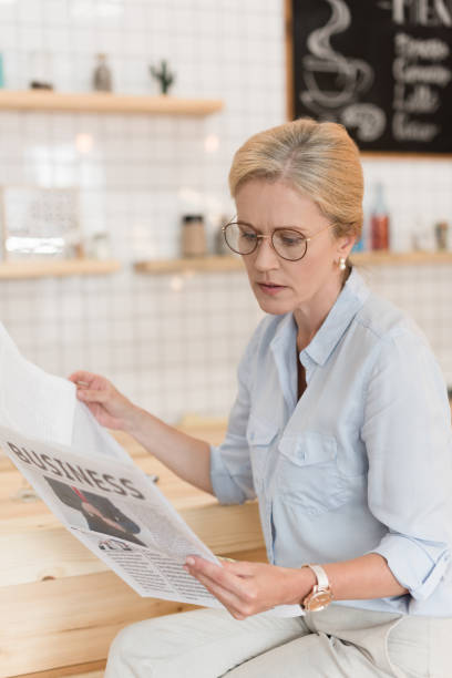 istock businesswoman reading newspaper 858248070