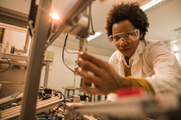 istock Black female engineer working on industrial machine in a laboratory. 858248362