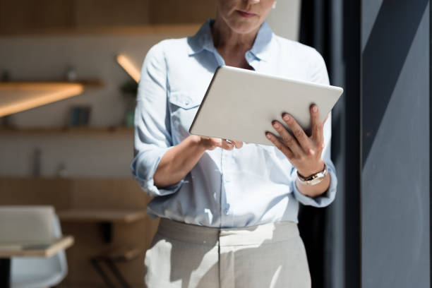 istock mature woman with digital tablet 858248698