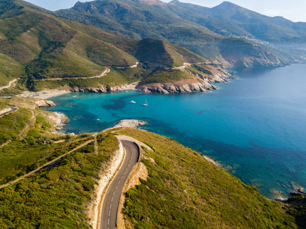 Aerial view of the coast of Corsica, winding roads and coves with crystalline sea. Cap Corse Peninsula, Corsica. Coastline. Anse d'Aliso. Gulf of Aliso. France Aerial view of the coast of Corsica, winding roads and coves with crystalline sea. Cap Corse Peninsula, Corsica. Coastline. Anse d'Aliso. Gulf of Aliso. France corsica photos stock pictures, royalty-free photos & images