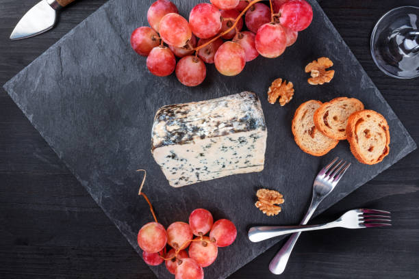 istock Blue cheese and grapes on black with copy space 858252662