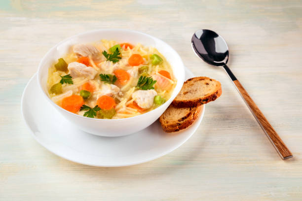 istock Chicken soup with noodles, bread, and copy space 858252798