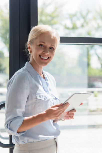 istock mature woman with digital tablet 858252982