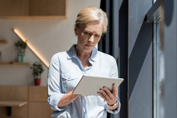 istock mature woman with digital tablet 858254188