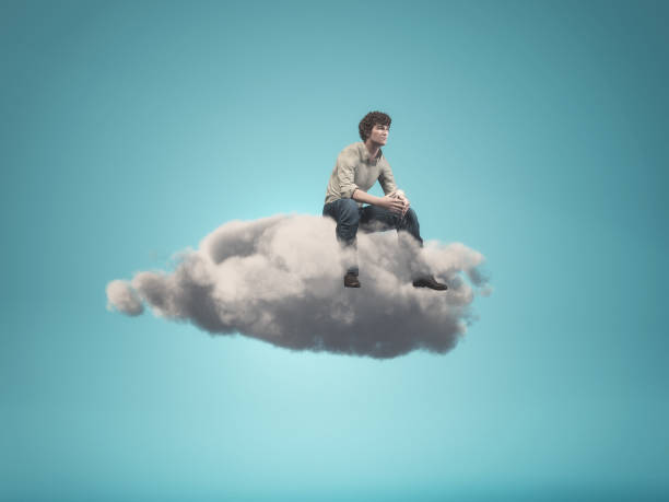 istock Surreal  image of a man sitting on a gray cloud 858259972