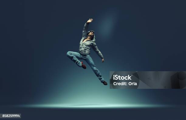 Jumping Man Strikes Pose Stock Photo - Download Image Now - Dancing, Street, Dancer