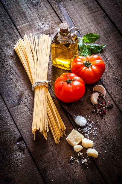 istock Spagetti with ingredients on rustic wooden table 858260538