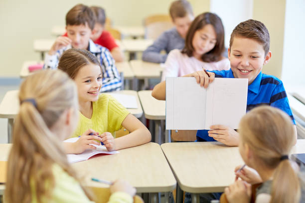 istock group of school kids writing test in classroom 858260638
