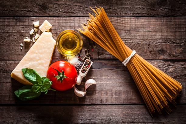 Wholegrain spaghetti with ingredients on rustic wooden table