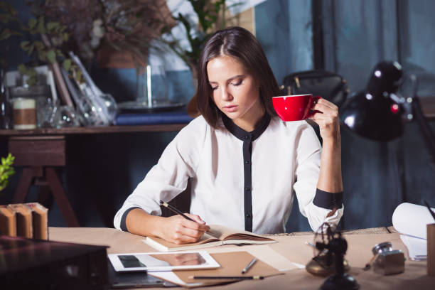 istock Young beautiful woman working with cup of coffee 858263138