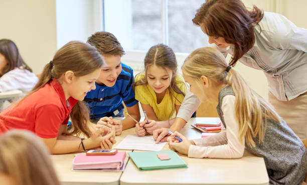 istock group of school kids writing test in classroom 858263950