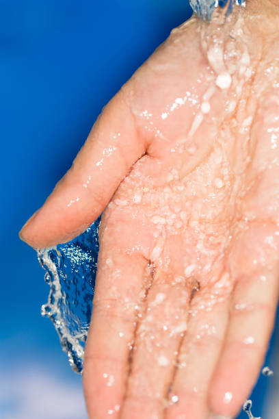 istock hand in the water on a blue background 858266776