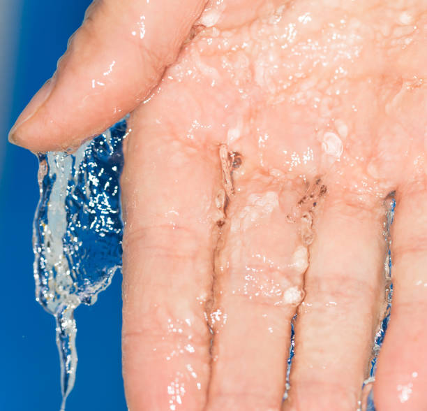 istock hand in the water on a blue background 858266880