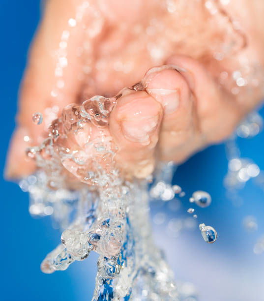 istock hand in the water on a blue background 858267012