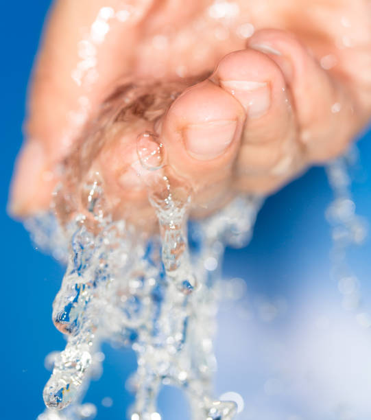 istock hand in the water on a blue background 858267100