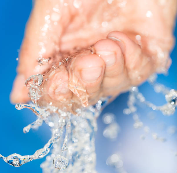 istock hand in the water on a blue background 858267152